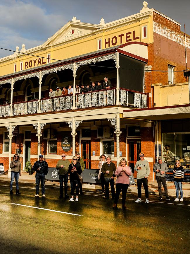 Alison McClelland (in pink) and locals outside the community-owned and operated Royal Hotel in Sea Lake, Vic. Picture: Julian Kingma