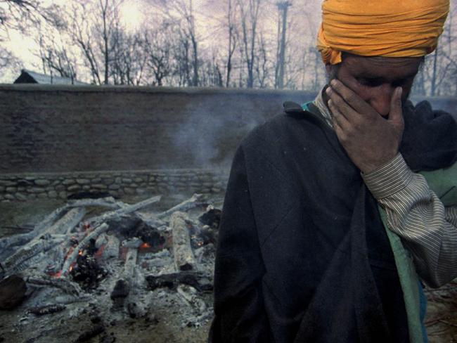 A Sikh man from the village of Chati Singhpura weeps as the remains of one of his relatives are cremated after a 2000 massacre. Picture: Lynsey Addario