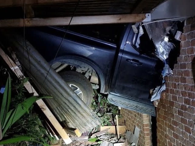 A car got airborne and launched into a house a P0rt Macquarie on Tuesday night. Picture: NSW Police