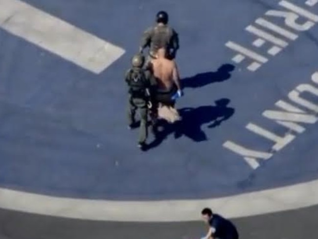 The injured male is helped up towards the flight in waiting. Picture: KTLA 5.