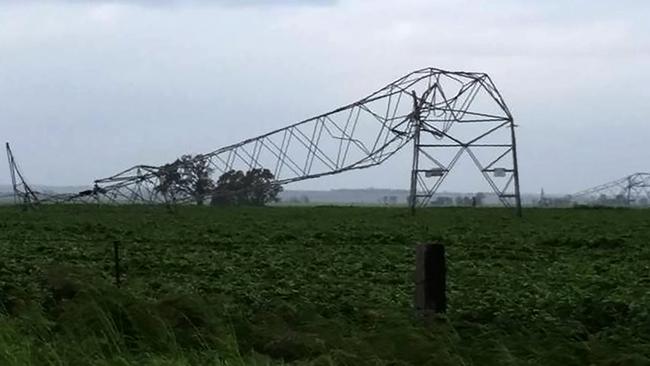 A photo taken on September 28 shows transmission towers carrying power lines, toppled by high winds near Melrose in South Australia after "unprecedented" thunderstorms triggered a statewide blackout. Picture: AFP Debbie Prosser