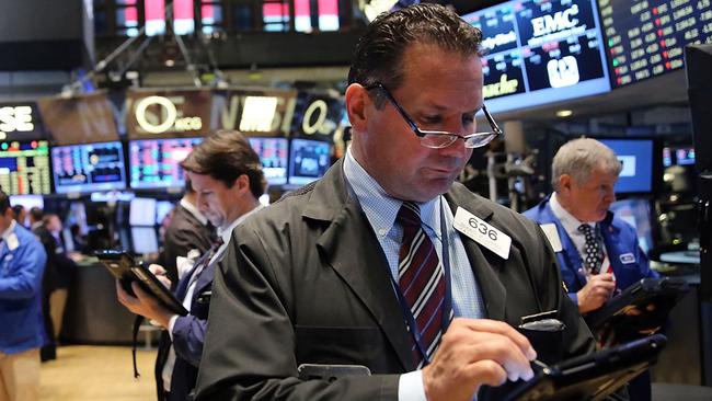 NEW YORK, NY - SEPTEMBER 11: Traders work on the floor of the New York Stock Exchange (NYSE) on September 11, 2015 in New York City. The Dow was down 50 points in morning trading. Throughout the nation people are holding somber gatherings and memorial events to reflect on the 14-year anniversary of the 9/11 attacks that resulted in the loss of nearly 3,000 people. Spencer Platt/Getty Images/AFP == FOR NEWSPAPERS, INTERNET, TELCOS & TELEVISION USE ONLY ==