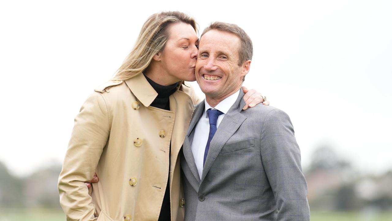 Damien Oliver gets a kiss from his wife after announcing he will retire later this year. Picture: Scott Barbour/Racing Photos via Getty Images