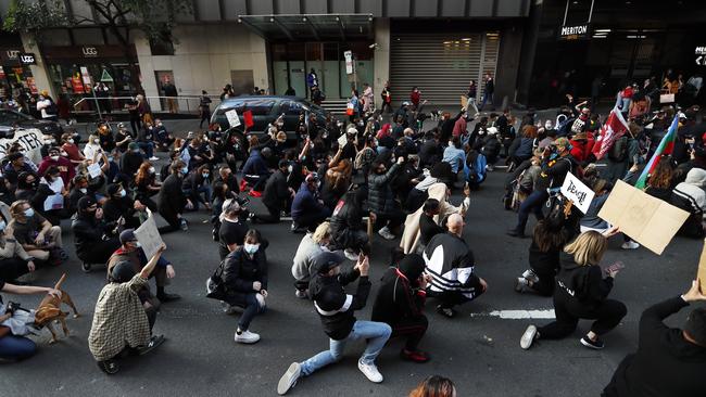 Black Lives Matter protesters take a knee in the middle of a Sydney street. Picture: Sam Ruttyn