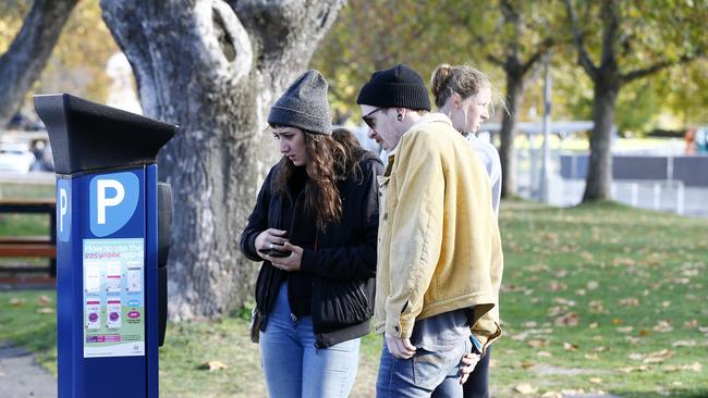 Hobart City Council is under fire about the new parking meters and how fines are issued for offences that are not made clear. Pictured is Joel Herron with his partner from Melbourne trying to make sense of it all. Picture: MATT THOMPSON