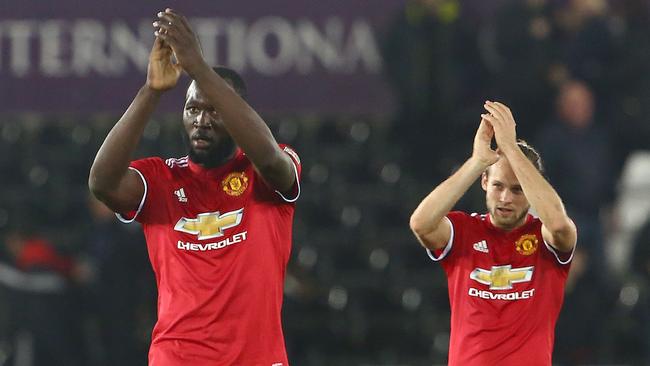 Manchester United's Belgian striker Romelu Lukaku (L) and Manchester United's Dutch midfielder Daley Blind