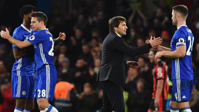 Chelsea's Italian head coach Antonio Conte (2R) shakes hands with his players.