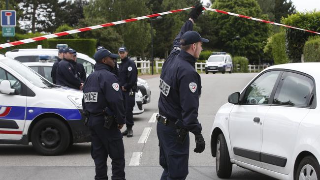 French police officers work at the crime scene the day after a knife-wielding attacker stabbed a senior police officer to death on Monday evening outside his home in Magnanville, west of Paris. Picture: AP.