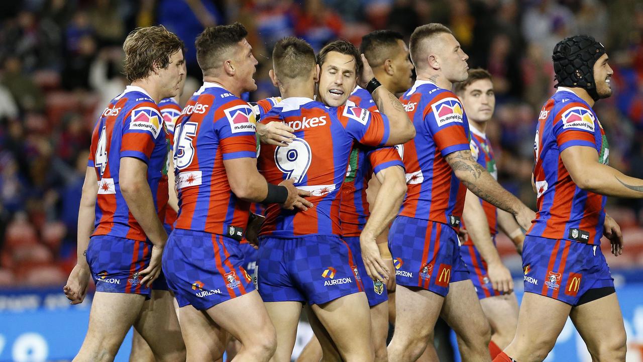 Mitchell Pearce celebrates a try with his teammates.