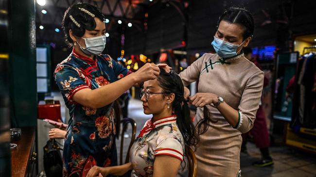 Stylists wearing arrange the hair of a passenger before boarding a last century-style boat featuring a theatrical drama set between the 1920s and 1930s in Wuhan. Picture: AFP