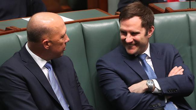 Peter Dutton and Alex Hawke chat amiably last week in the House of Representatives Chamber. Picture: Kym Smith