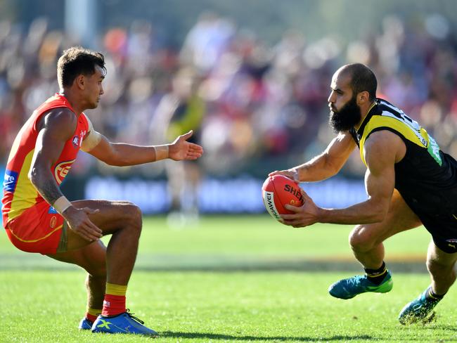 Bachar Houli of the Tigers (right) is tackled by Callum Ah Chee of the Suns during the Round 21 AFL match between the Gold Coast Suns and the Richmond Tigers at Metricon Stadium on the Gold Coast, Saturday, August 11, 2018. Picture: AAP Image/Darren England