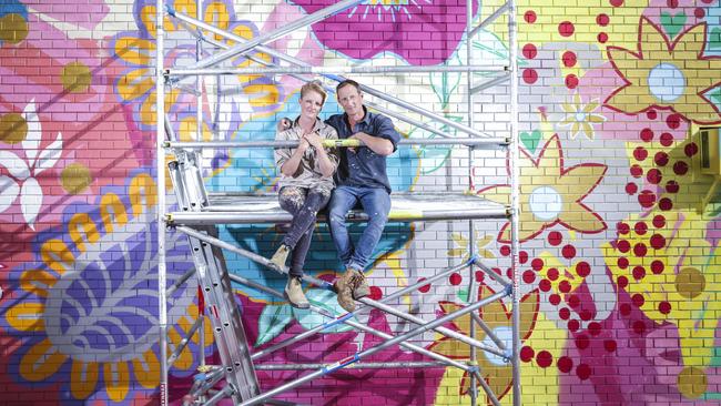 Husband and wife team Rowena Martinich and Geoffrey Carran with their mural in Dandenong’s Little India precinct. Picture: Wayne Taylor