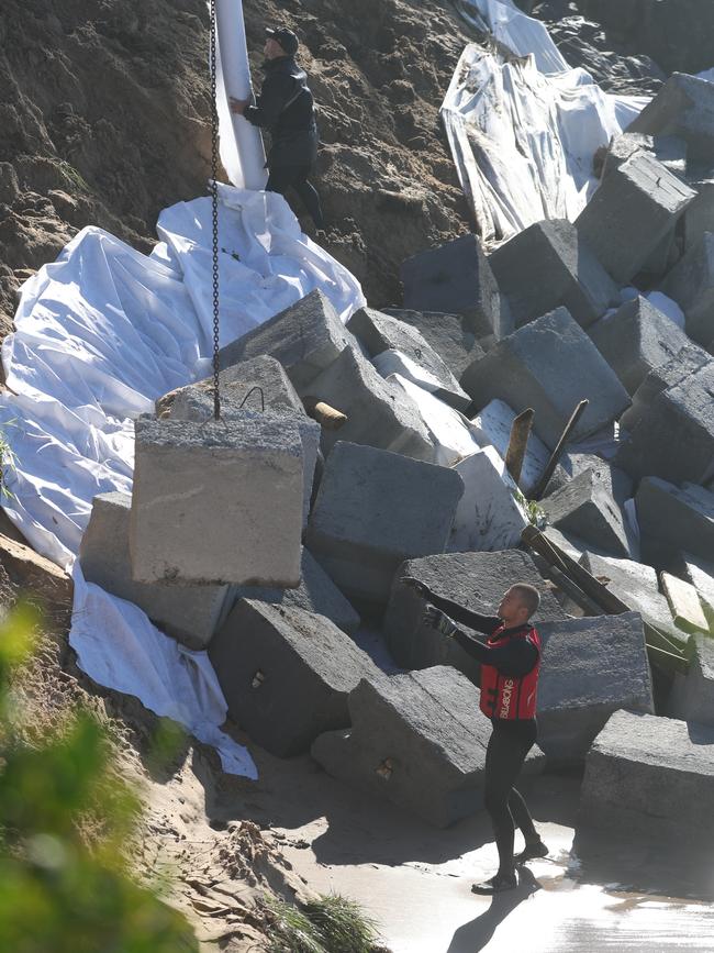 Heavy cement blocks being lowered in front homes on Ocean View Dr. Picture: John Grainger