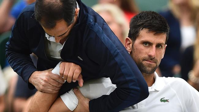 Novak Djokovic receives medical treatment at during his Wimbledon match against Adrian Mannarino. Picture: AFP