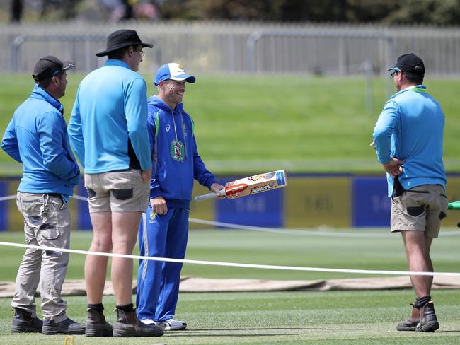 CRICKET: Wednesday 9th November 2016, Blundstone Arena: Australian opener David Warner chats with Blundstone Arena curator Marcus Pamplin (right) and staff in the middle. Picture: LUKE BOWDEN