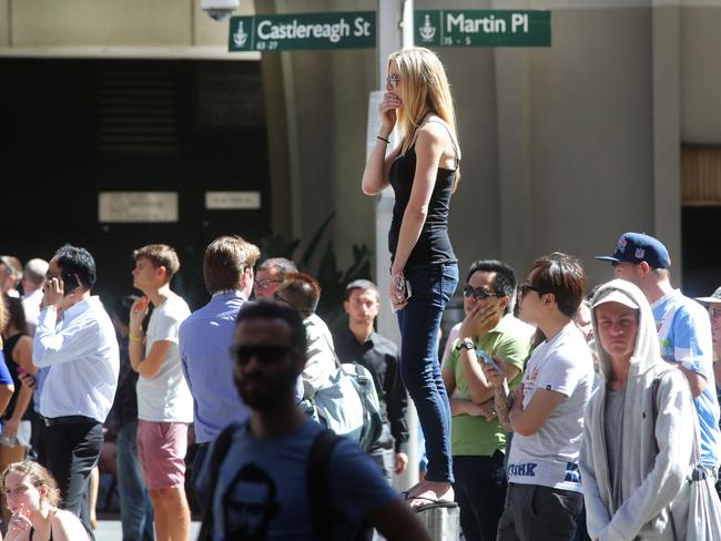 People gather in Martin Place to try and see the siege at Lindt cafe in Martin Place. Picture Cameron Richardson.