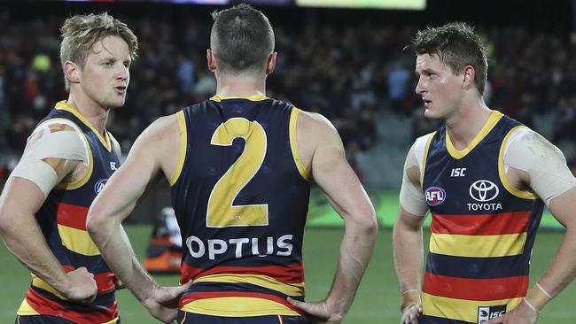 Rory Sloane with Brad and Matt Crouch after the Crows’ loss to Essendon. Picture: Sarah Reed