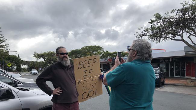 Protester Lee Stapleton outside the council chambers with his placard asking motorists to honk if they wanted the mayor to resign