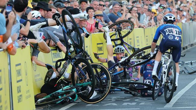 The crash on last corner with two riders going over the barricade including Tobias Bayer of team DS: Meersman Gianni during day two of the Tour Down Under 2025. Picture: Sarah Reed/Getty Images