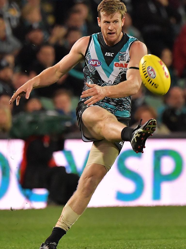 Port Adelaide Tom Jonas kicks the ball forward against Richmond at Adelaide Oval. Picture: Daniel Kalisz/Getty