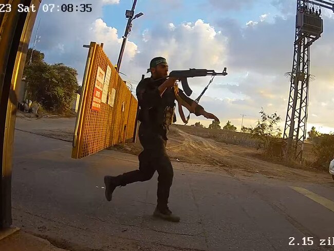 An armed man runs aiming his gun during the October 7 attack by Hamas, in this screen grab from footage captured by a surveillance camera in Kibbutz Alumim, Israel, and released November 20, 2023. Photo: @Israel / X