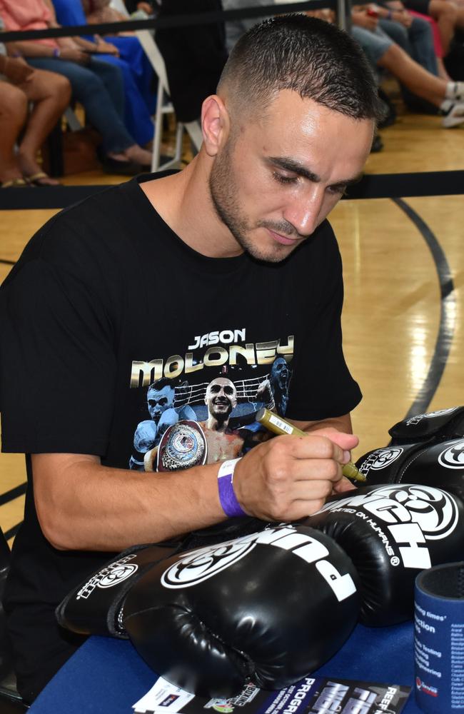 WBO bantamweight world champion Jason Moloney signs some gloves at the Reef 'n' Beef Fight Night at Rockhampton’s Bravus Arena.