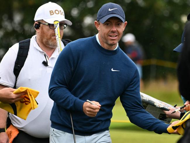 Northern Ireland's Rory McIlroy signs autographs for fans during a practice round ahead of the 152nd British Open Golf Championship at Royal Troon on the south west coast of Scotland on July 16, 2024. (Photo by ANDY BUCHANAN / AFP) / RESTRICTED TO EDITORIAL USE