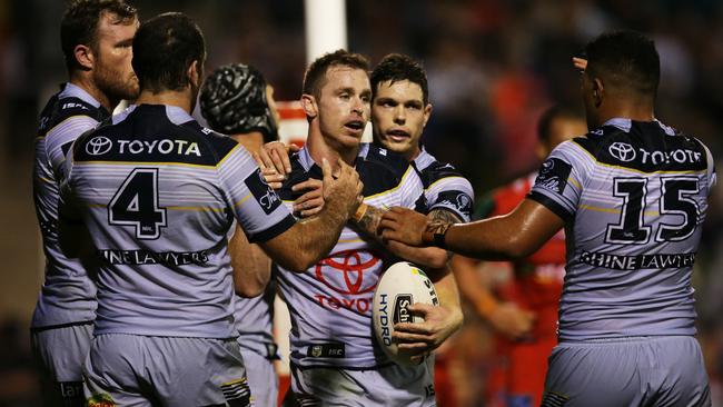 Michael Morgan celebrates a try with his Cowboys teammates. Picture: Toby Zerna