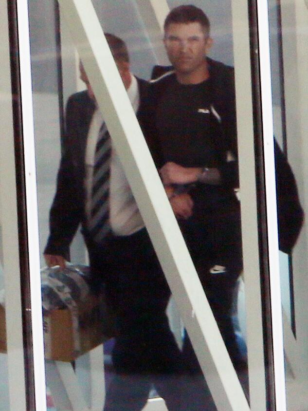 Alleged murderer Aaron Donald Carver is escorted off a flight from Brisbane to Adelaide with detectives. Less than 24 hours after his arrest, police asked for a 14-month adjournment. Picture: AAP / Emma Brasier