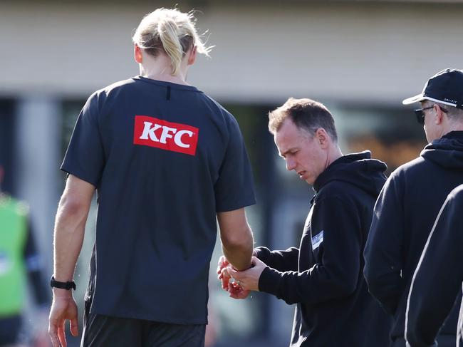 MELBOURNE, AUSTRALIA - September 11 , 2023. AFL.    Club medico checks out Darcy Moores right hand/wrist during CollingwoodÃs training session at Olympic Park   Photo by Michael Klein.