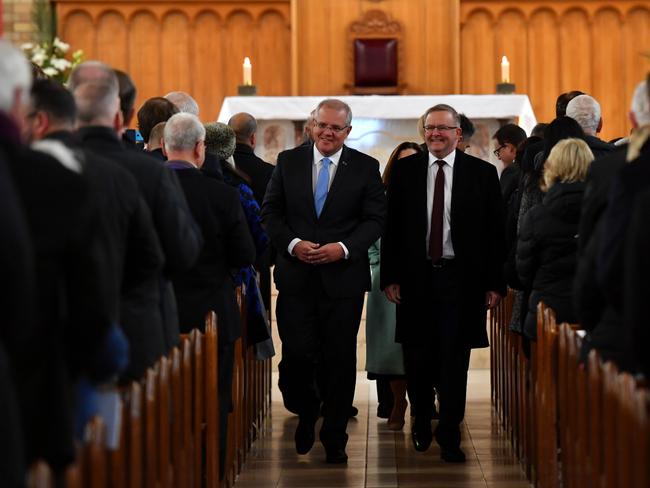 Prime Minister Scott Morrison (left) and Opposition leader Anthony Albanese (right) are seen departing a Parliamentary church service for the commencement of parliament at the St Christopher's Catholic Cathedral in Manuka, in Canberra. Picture: AAP