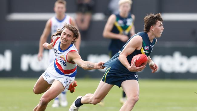 Finn O'Sullivan breaks away from a tackle for the AFL Academy. Picture: Michael Willson/AFL Photos via Getty Images