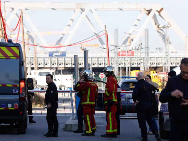 French police officers, next to firefighters, block the access to the SNCF's freight area in Saint-Denis. Picture: AFP