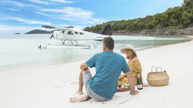 Couple enjoying a picnic on Whitehaven Beach. Picture: Tourism and Events Queensland