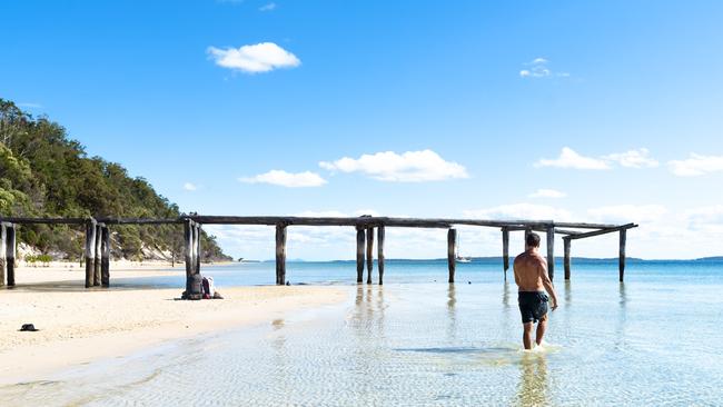 Man walking through the water at McKenzie Jetty.