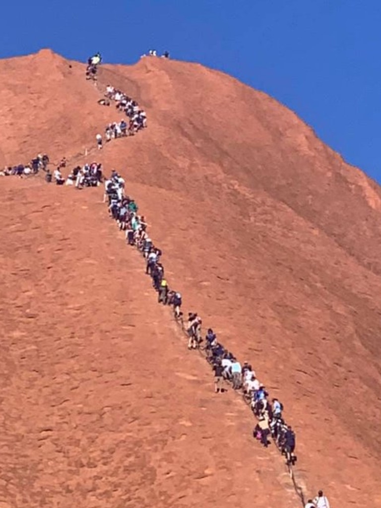 A huge line of tourists climbing up Uluru yesterday. Picture: Glenn Minett