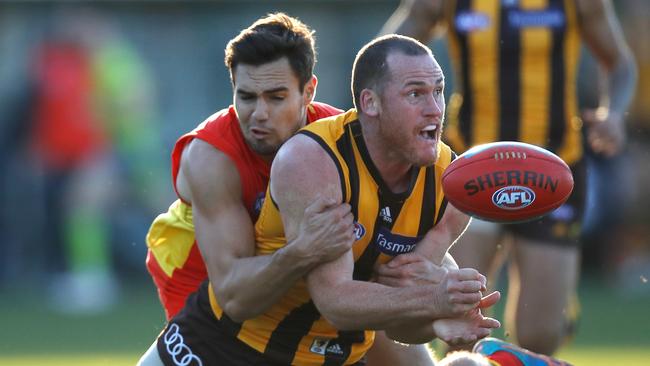 Gold Coast Suns defender Jack Leslie wraps up Hawthorn’s Jarryd Roughead. Picture: Michael Willson/AFL Media/Getty Images