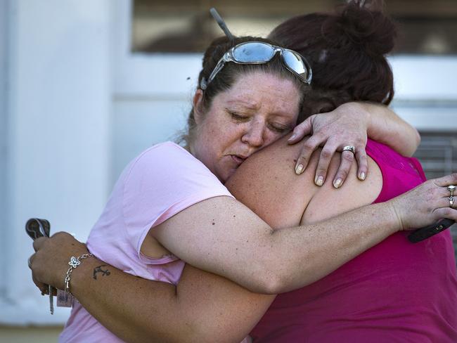 Locals comfort one another moments after the shooting. Picture: Nick Wagner/Austin American-Statesman via AP