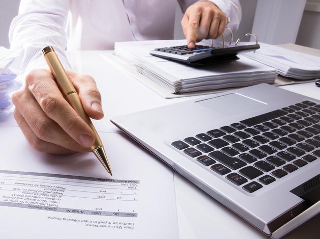 Close-up Of Accountant Calculating Invoice Using Calculator And Pen In Office