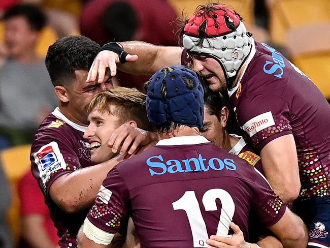 BRISBANE, AUSTRALIA - SEPTEMBER 05: Tate McDermott of the Reds is congratulated by team mates after scoring a try during the round 10 Super Rugby AU match between the Reds and the Brumbies at Suncorp Stadium on September 05, 2020 in Brisbane, Australia. (Photo by Bradley Kanaris/Getty Images)