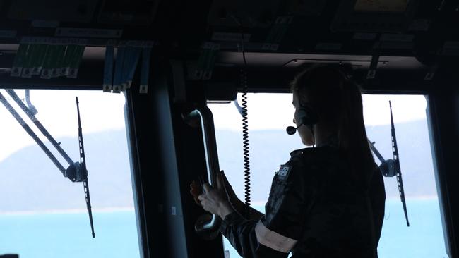 A Royal Australian Navy sailor from HMAS Brisbane on the bridge during search and rescue operations in the vicinity of Lindeman Island, Queensland, 29 July 2023.