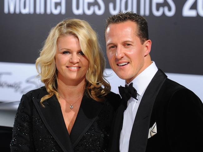 Formula-One driver Michael Schumacher and his wife Corinna arrive for the GQ gala 'Men of the Year' in Berlin on October 29, 2010.  AFP PHOTO / JENS KALAENE  GERMANY OUT / AFP PHOTO / DPA / JENS KALAENE