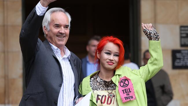 Extinction Rebellion members Ian Fox and Ngoc Nguyen celebrating outside the Adelaide Magistrates Court after they were sentenced for disturbing the peace. Photo: NCA NewsWire/David Mariuz