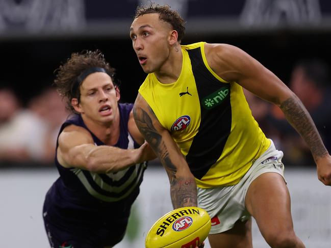 PERTH, AUSTRALIA - JUNE 10: Shai Bolton of the Tigers looks to handball against NFduring the round 13 AFL match between Fremantle Dockers and Richmond Tigers at Optus Stadium, on June 10, 2023, in Perth, Australia. (Photo by Paul Kane/Getty Images)