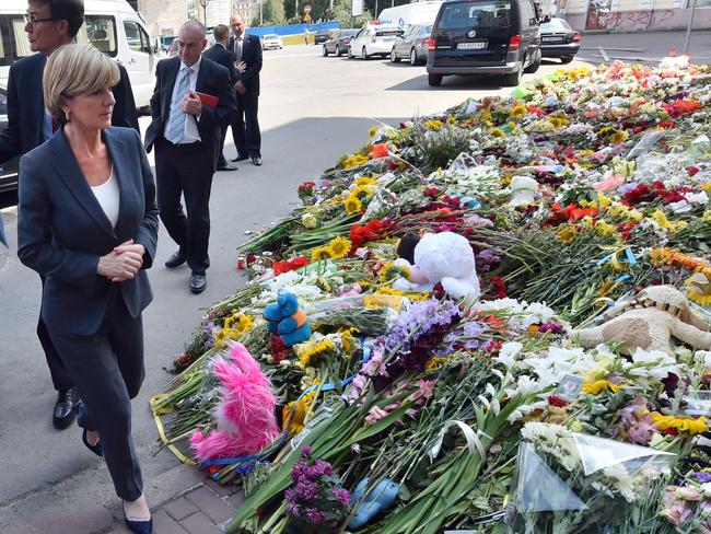 Foreign Minister Julie Bishop walks past flowers laid in memory of the victims of downed Malaysia Airlines flight MH17 in front of the Netherlands' embassy in Kiev. Picture: AFP Photo/Sergei Supinsky