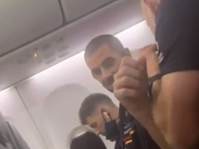 Luke Brown and Taylor Walker seen without masks on their flight to Adelaide.