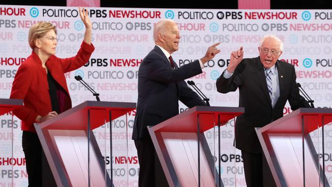 Elizabeth Warren, Joe Biden and Bernie Sanders struggle to get a word in during the Democratic presidential debate in Los Angeles. Picture: Getty Images.