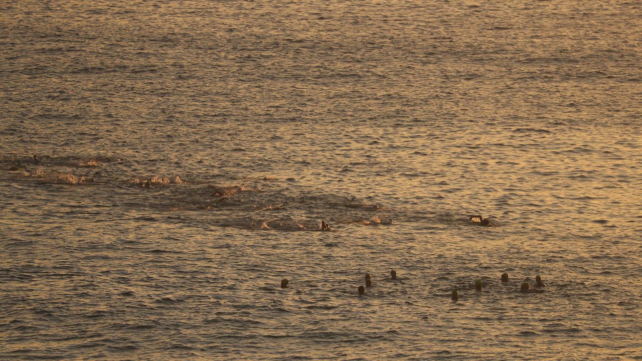 The Bondi Salties during their swim from the beach’s north to south end, before they held a minute’s silence for shark attack victim Simon Nellist. Picture: John Grainger