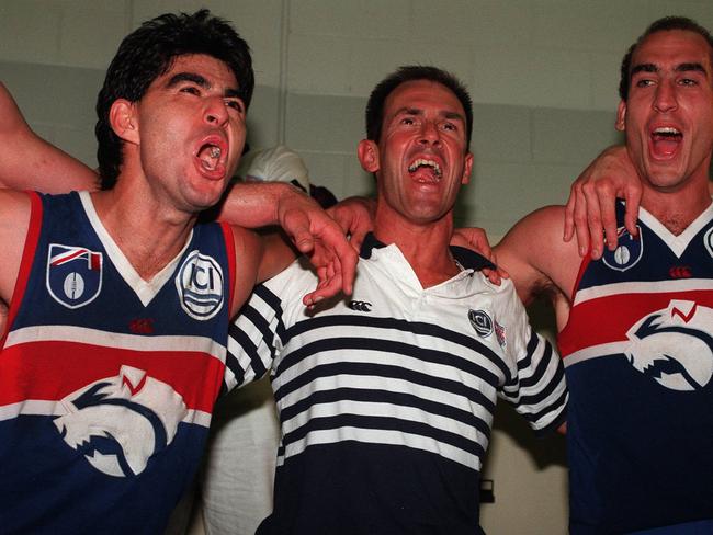 Western Bulldogs coach Terry Wallace sings the club song with Jose Romero (left) and Matthew Croft following a victory in 1997.